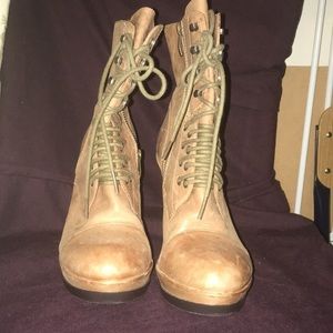 Tan distressed wedge boots.